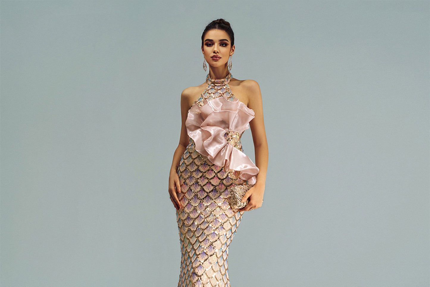 Elegant evening gown with floral details on a plain background