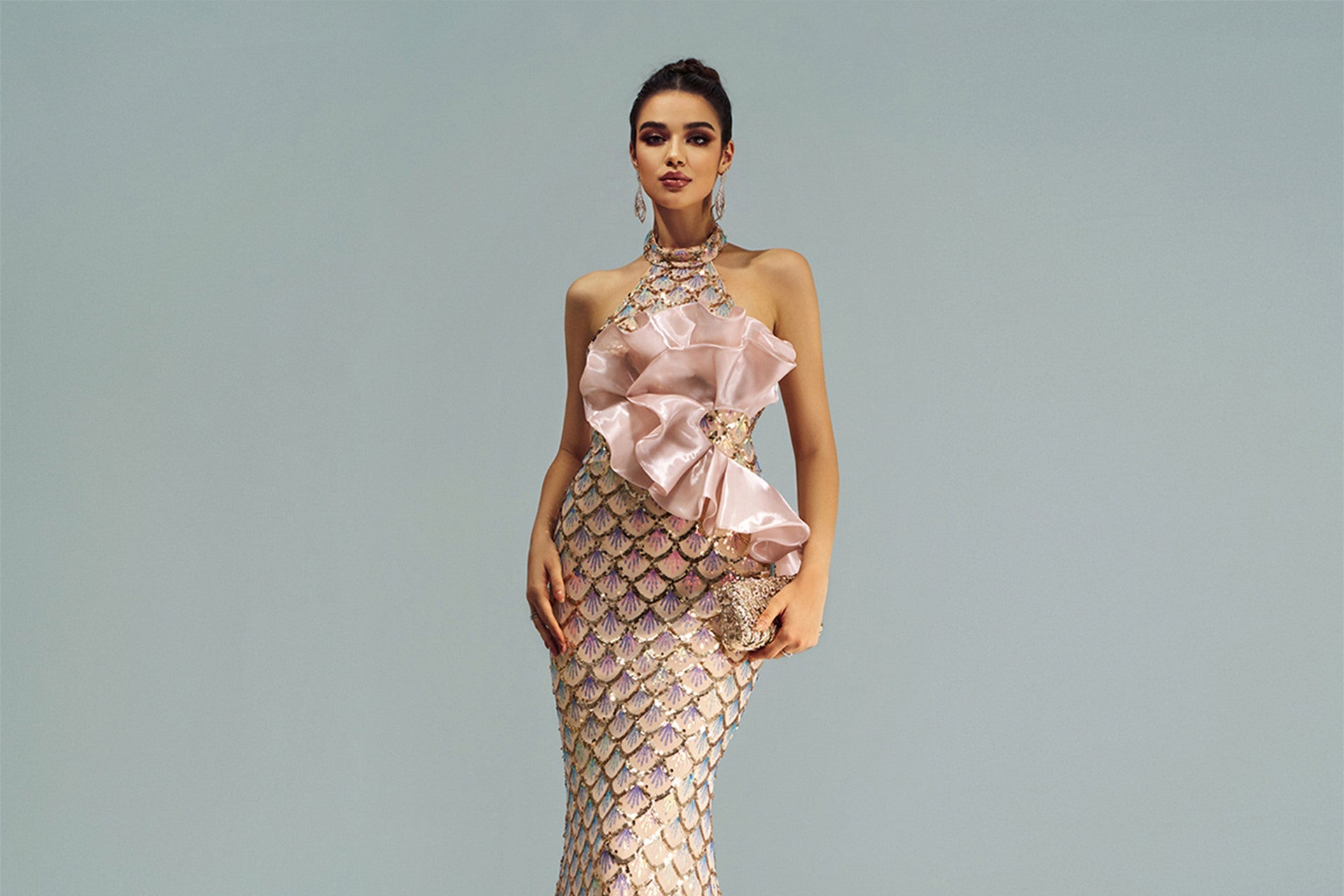 Elegant evening gown with floral details on a plain background